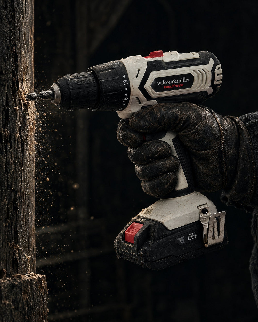 Gloved hand drilling into dark timber with a Fieldforce 20V cordless drill